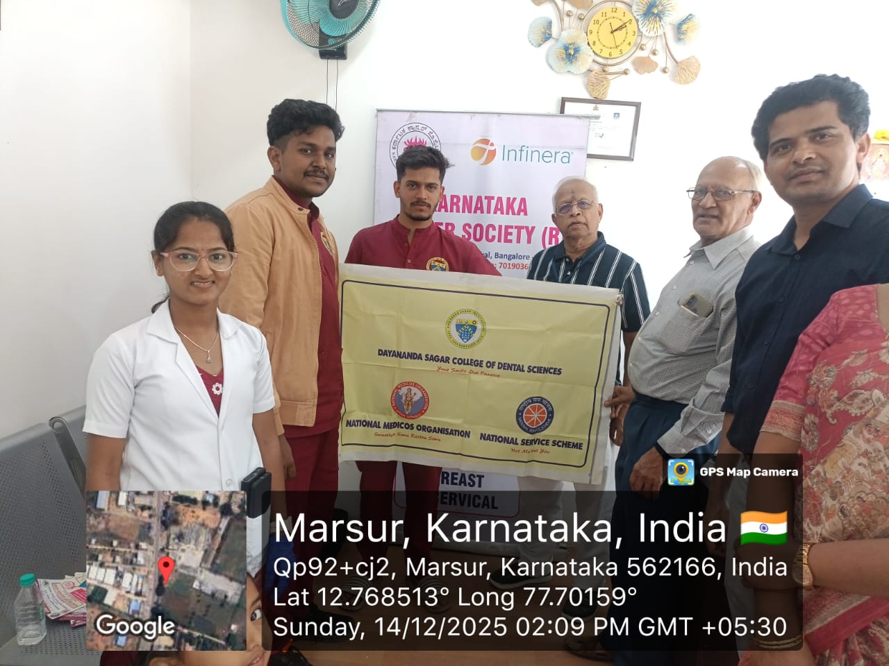 Group photo of the dental camp team and organizers with a banner